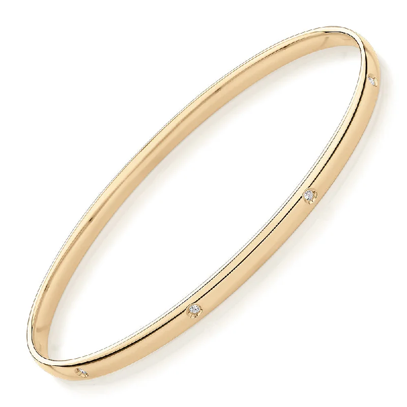 Oval bangle with diamond simulants in 10 carat yellow gold