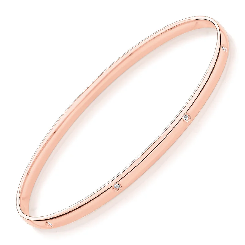 Oval bangle with diamond simulants in 10 carat rose gold